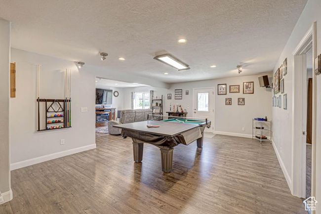 Playroom with baseboards, wood finished floors, and pool table | Image 13
