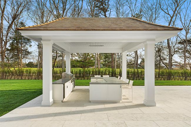 Outdoor Kitchen BBQ with full kitchen and recessed drop down tv & heaters | Image 36