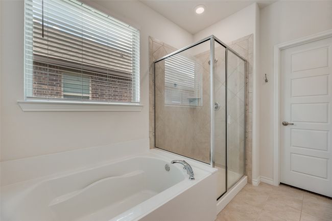 Full bathroom featuring a garden tub, a shower stall, plenty of natural light, and tile patterned flooring | Image 25