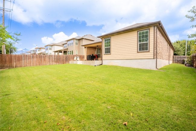 Rear view of house with a fenced backyard | Image 27