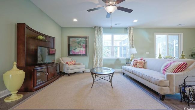 Living room with baseboards, wood finished floors, a ceiling fan, and recessed lighting | Image 10