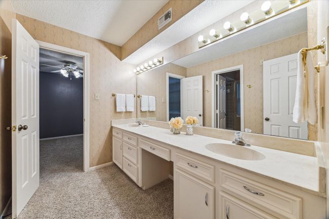 This 11’x9’ secondary shared bathroom, with large double sink vanity, has a separate tub/shower and toilet area for additional privacy. | Image 27