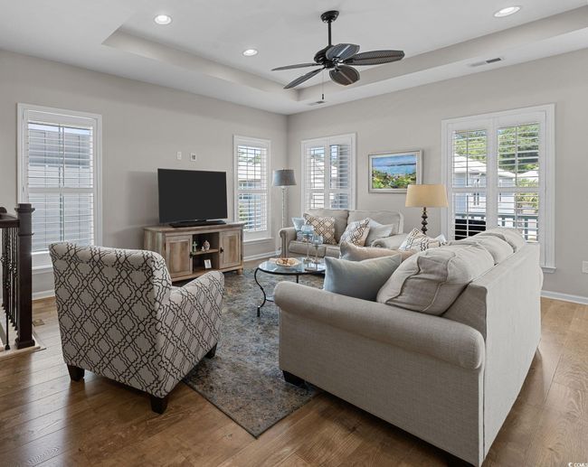 Living room featuring wood finished floors, healthy amount of natural light, and recessed lighting | Image 10