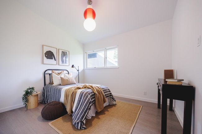 Bedroom featuring wood finished floors and lofted ceiling | Image 19