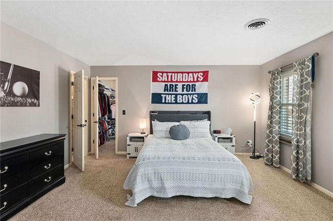 Bedroom with light carpet, a spacious closet, and a closet | Image 35