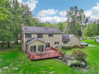 A rear view of this exceptional home showing the large deck and landscaped garden | Image 3