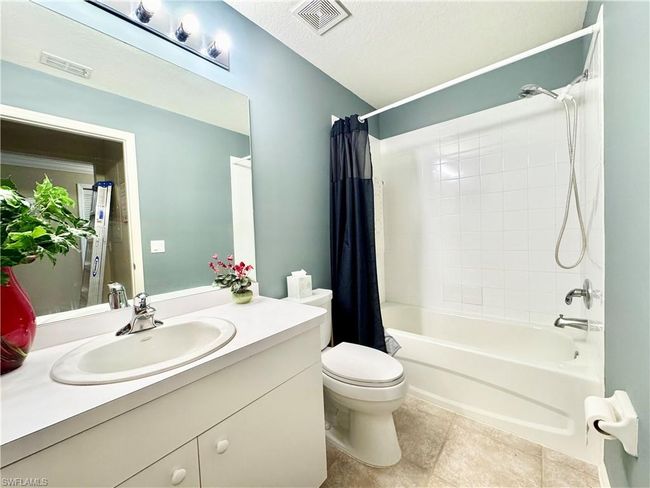 Full bath featuring visible vents, toilet, vanity, and shower / bath combo | Image 23