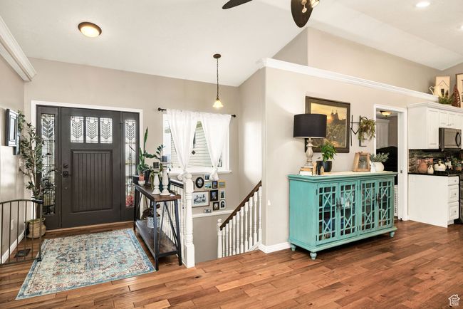 Foyer featuring lofted ceiling, a ceiling fan, wood finished floors, and recessed lighting | Image 4