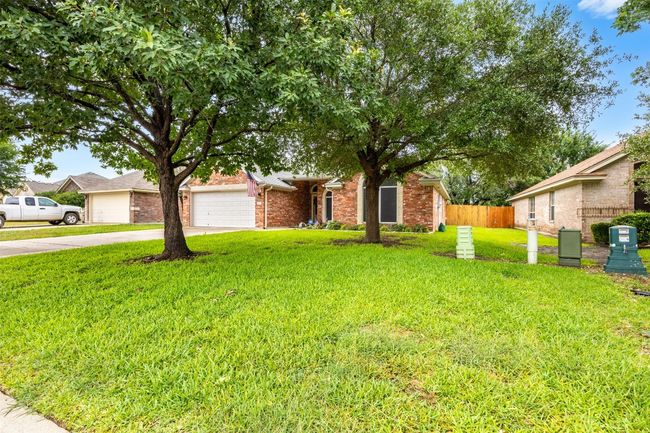 Obstructed view of property with driveway and brick siding | Image 4