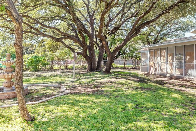 View of yard featuring a fenced backyard and a sunroom | Image 37