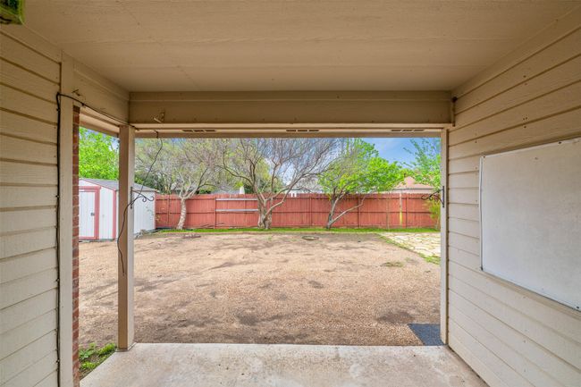 View of yard with a storage unit, a patio area, a fenced backyard, and an outdoor structure | Image 20