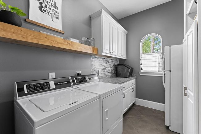Large sized utility room with plenty of storage and fits a full sized refrigerator. | Image 23