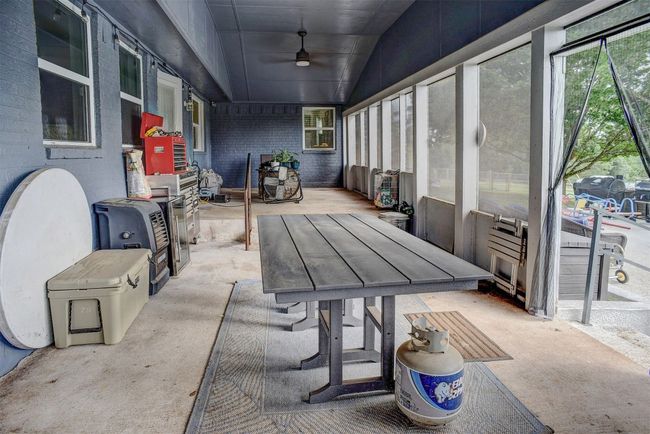 Sunroom / solarium with ceiling fan, outdoor dining space, and vaulted ceiling | Image 31