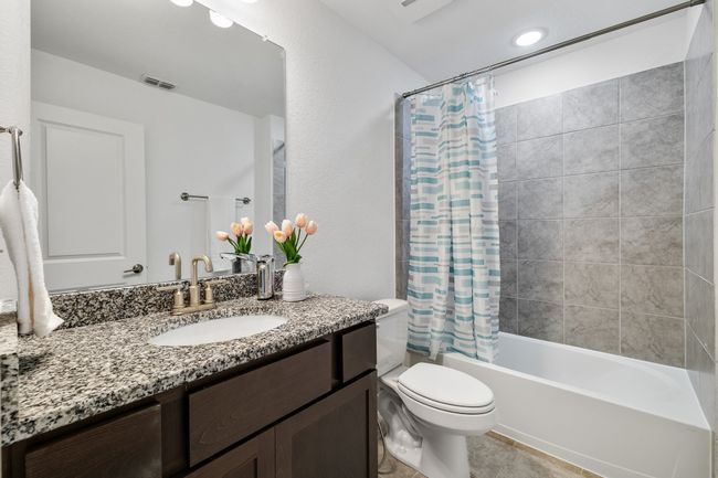Full bathroom with shower / bath combo, vanity, tile patterned floors, and toilet | Image 23