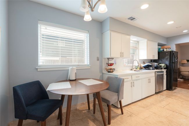 Big windows make this kitchen light and bright, quartz countertops, stainless steel appliances, easy maintenance tile floors | Image 20