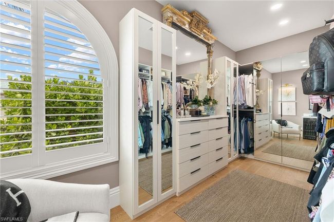 Spacious closet featuring light wood-type flooring | Image 26