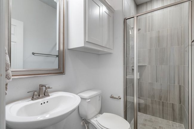 Bathroom featuring a sink and a stall shower | Image 17