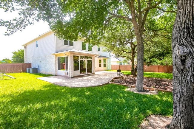 Rear view of property featuring a patio area, a fenced backyard, and brick siding | Image 33