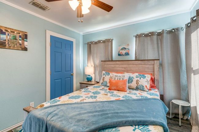Bedroom featuring visible vents, wood finished floors, ceiling fan, and ornamental molding | Image 13