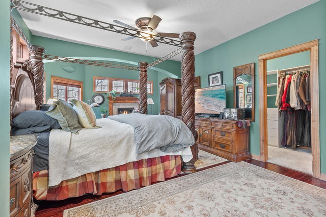 Primary bedroom suite with view toward sitting area with fireplace and door to full length covered deck. Entry to first walk-in closet shown. Wired LAN available | Image 21