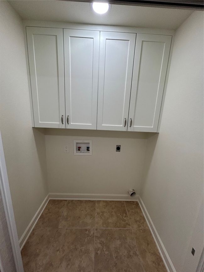 Washroom with electric dryer hookup, baseboards, cabinet space, and washer hookup | Image 8