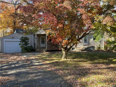 Obstructed view of property with a garage and a front lawn | Image 3