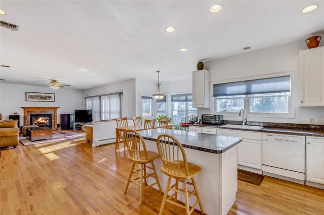 Kitchen with pendant lighting, white dishwasher, sink, and white cabinets | Image 9