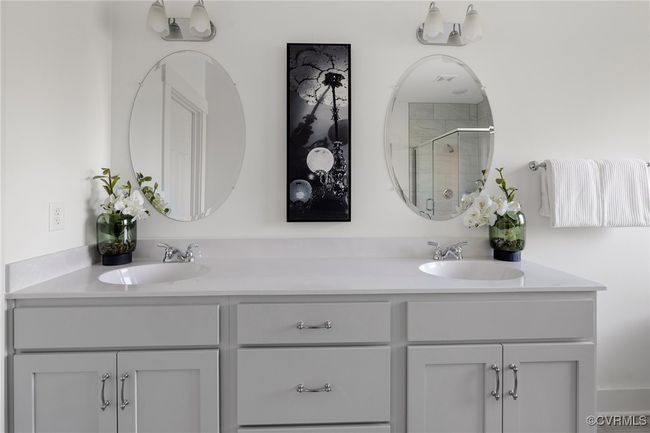 Luxurious primary bath with double vanity, soaking tub, and spa-inspired design. | Image 25