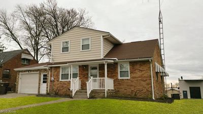 View of front property featuring a garage and a front yard | Image 1