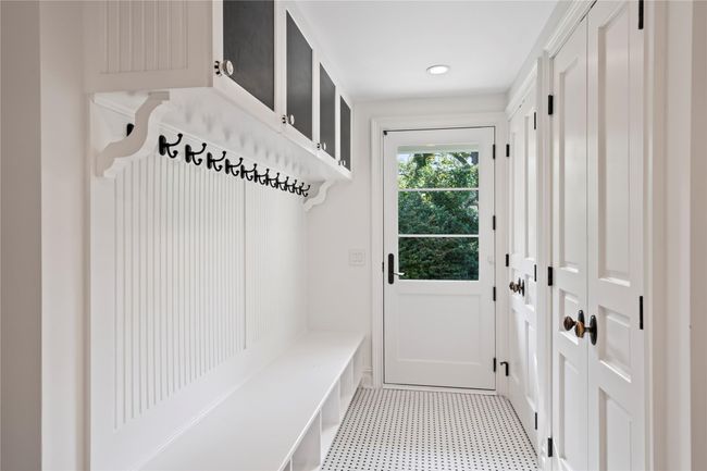 Clothes washing area with cabinets, separate washer and dryer, ornamental molding, and sink | Image 17