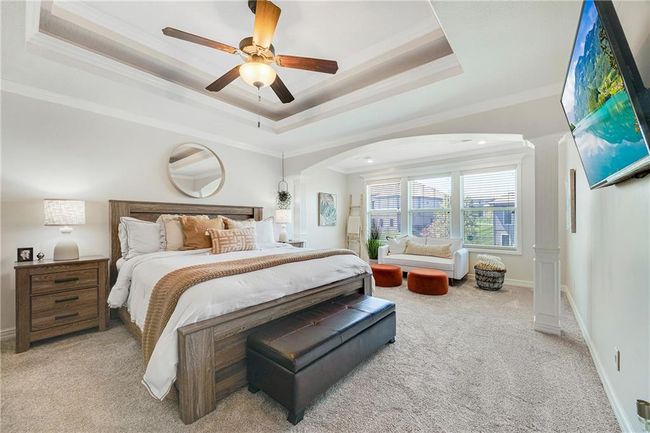 Primary bedroom with carpet, ceiling fan, view of the seating area. | Image 26