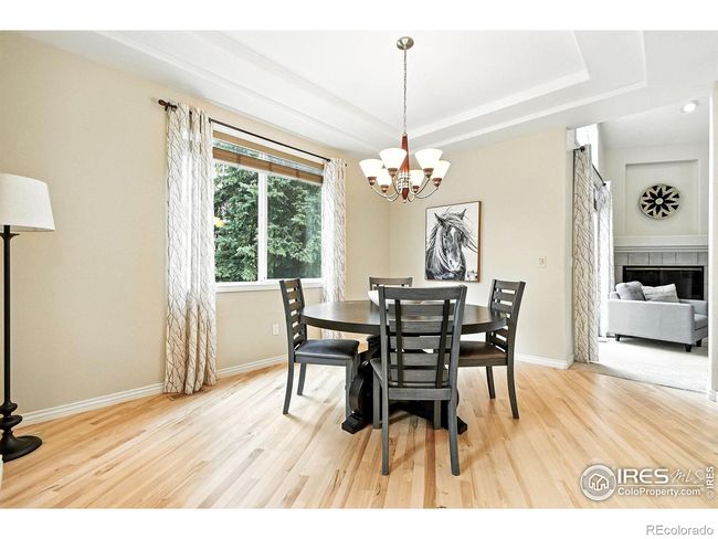 The separate dining room is enhanced by a coffered ceiling design. | Image 7