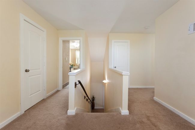Corridor with an upstairs landing, carpet floors, and baseboards | Image 19