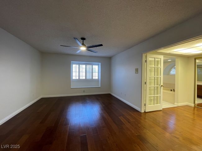 Unfurnished room featuring ceiling fan, dark wood-type flooring, and a textured ceiling | Image 24