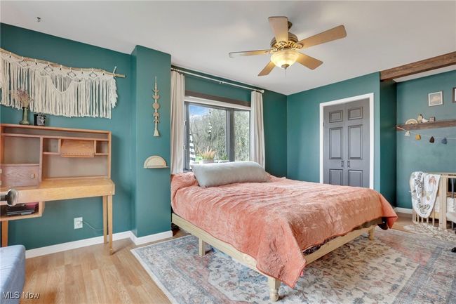 Bedroom with wood finished floors, ceiling fan, and a closet | Image 18