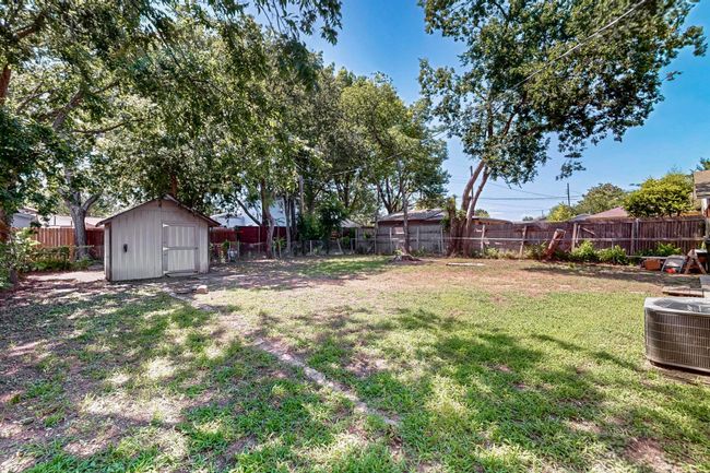 Fenced backyard featuring a storage shed | Image 29
