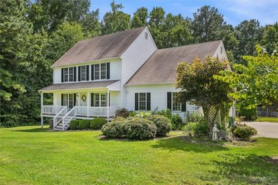 Colonial home featuring a front lawn and covered porch | Image 3