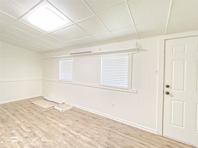 Unfurnished room featuring light wood-style floors and a drop ceiling | Image 27