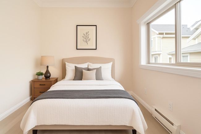 Bedroom featuring a baseboard heating unit, wood finished floors, and ornamental molding | Image 6