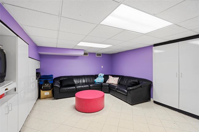 Living area with a paneled ceiling | Image 21