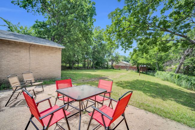 View of patio with a fenced backyard | Image 27