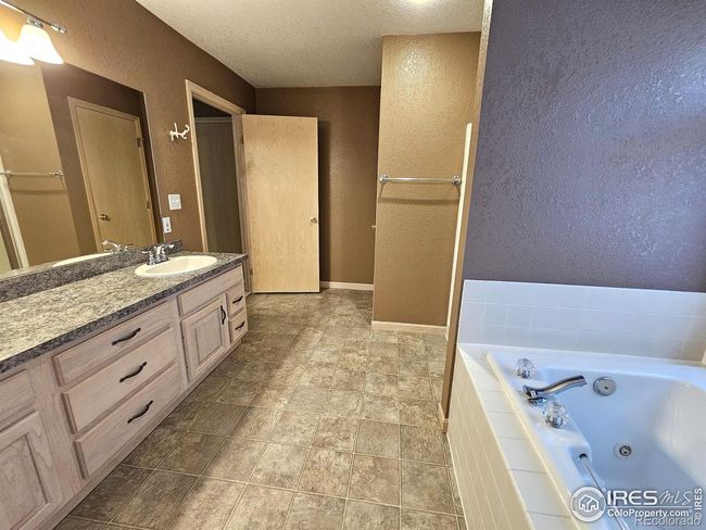 Jetted tub is beside the shower | Image 22