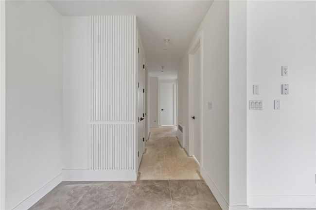 Hallway featuring visible vents and baseboards | Image 9