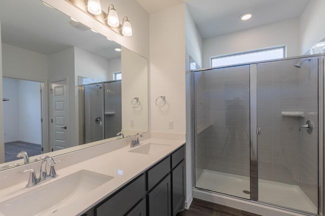 Bathroom featuring a stall shower, double vanity, and a sink | Image 28