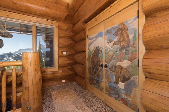 Custom carved and painted double doors to Primary Suite. | Image 11