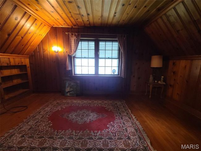 Additional living space featuring wood walls, vaulted ceiling, wood finished floors, and wooden ceiling | Image 18