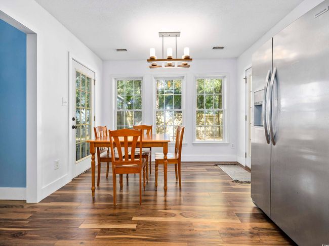 Dining room with baseboards, dark wood finished floors, plenty of natural light, and visible vents | Image 14