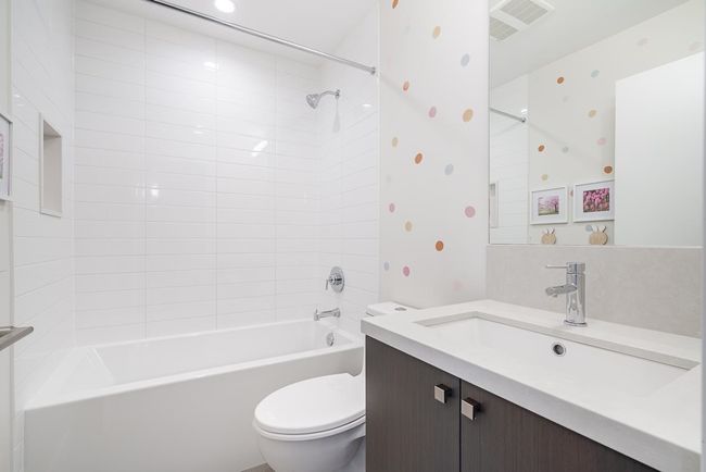 Full bath featuring visible vents, tub / shower combination, wallpapered walls, toilet, and vanity | Image 24