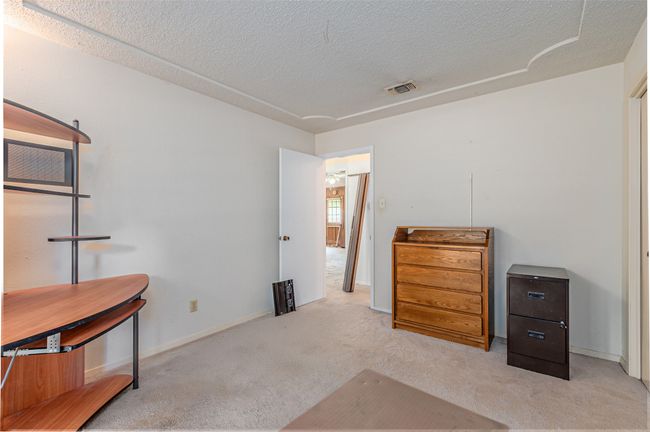 Bedroom with visible vents, a textured ceiling, and carpet | Image 9