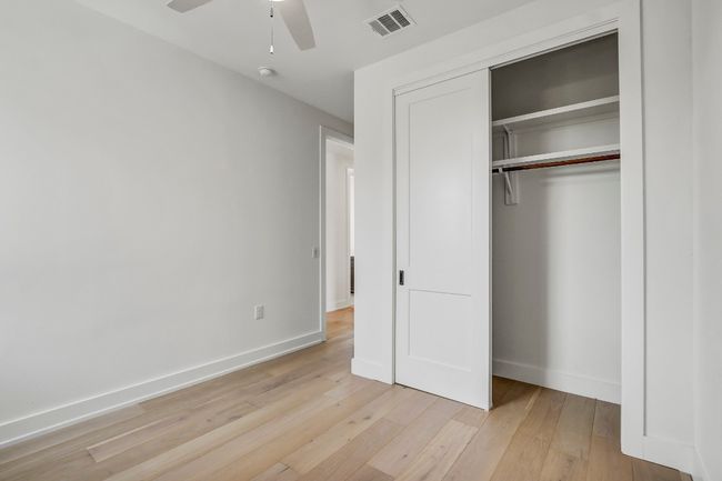 Unfurnished bedroom with baseboards, a closet, light wood-style flooring, and a ceiling fan | Image 19